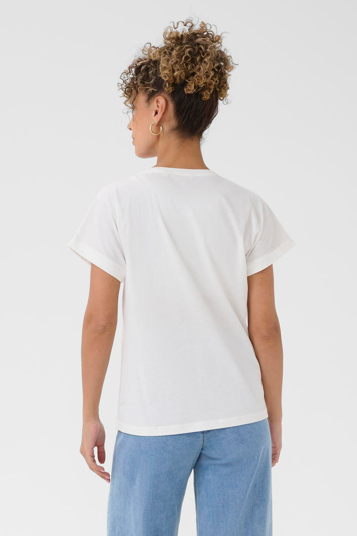 Person wearing a plain white t-shirt and light blue jeans on a white background