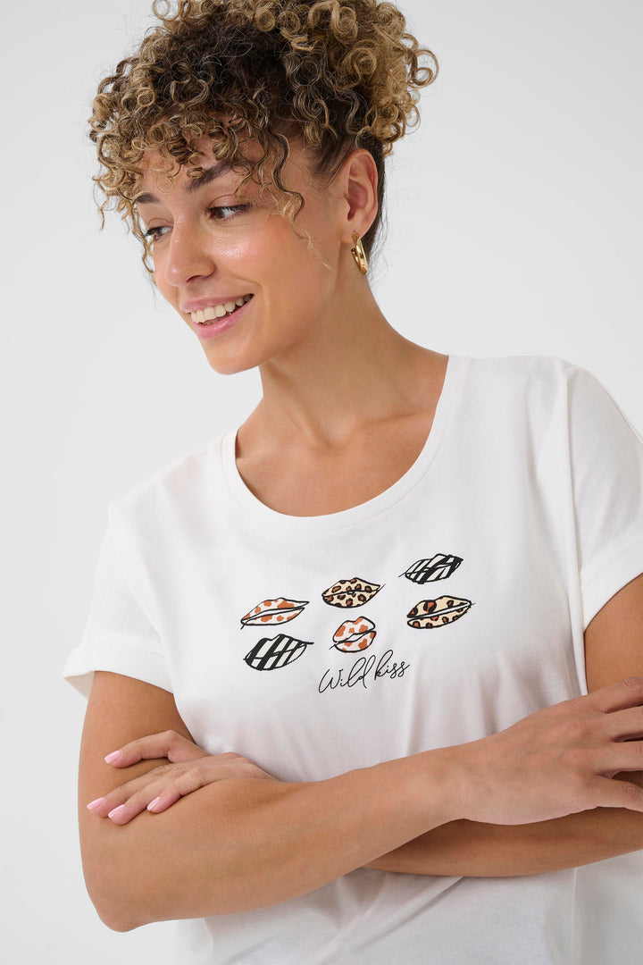 Woman wearing a white t-shirt with lip print designs and text on a plain background