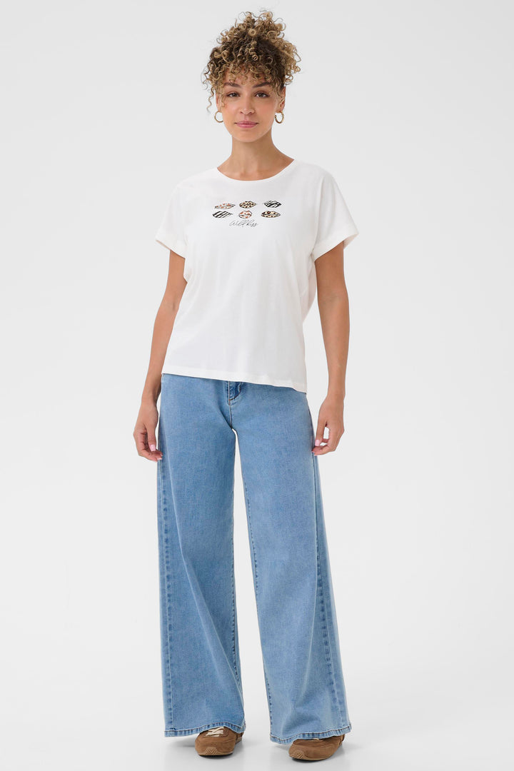 Person wearing a white t-shirt with graphic design and light blue jeans on a white background