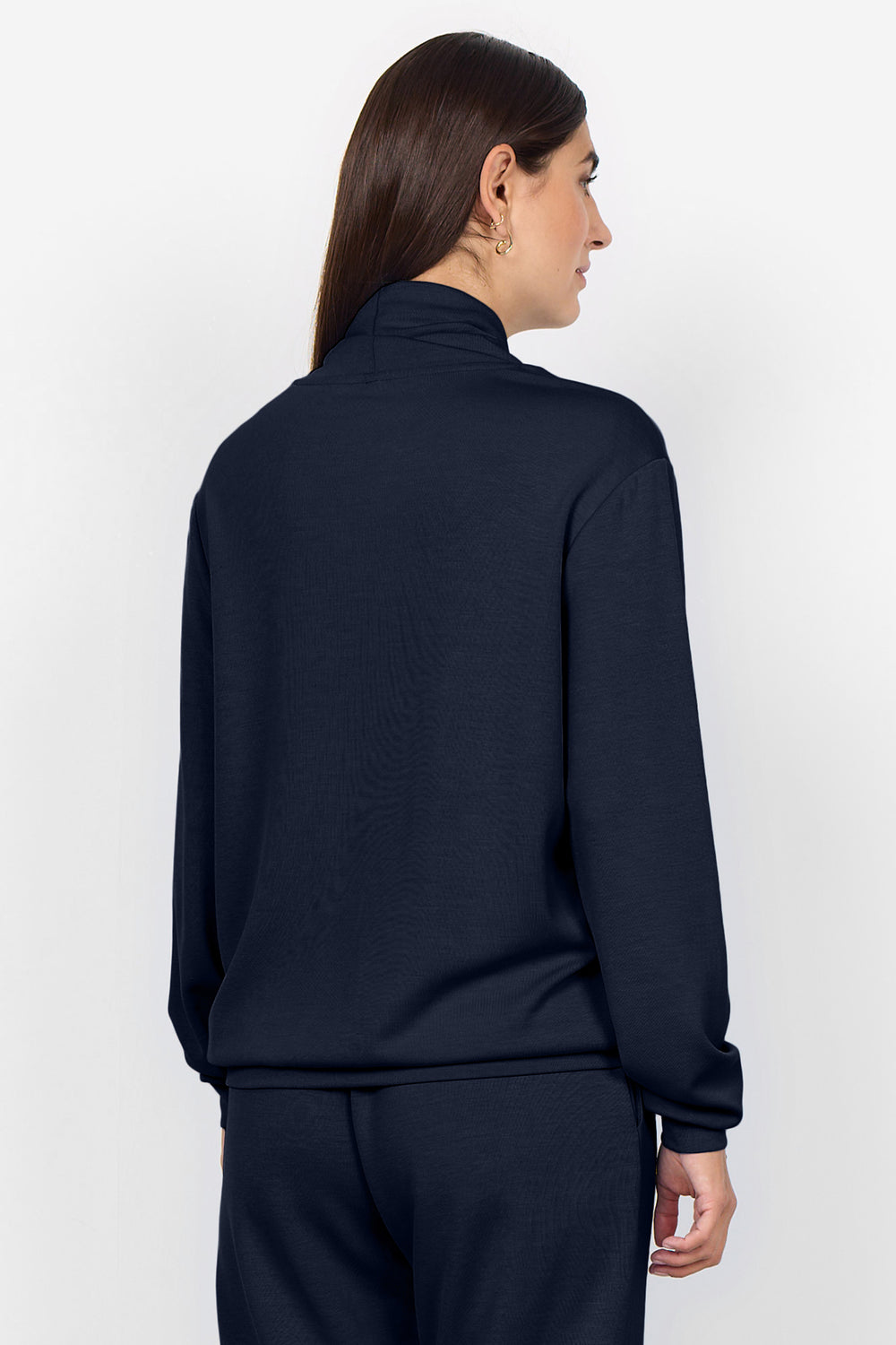 Person wearing a navy blue long-sleeve top on a white background