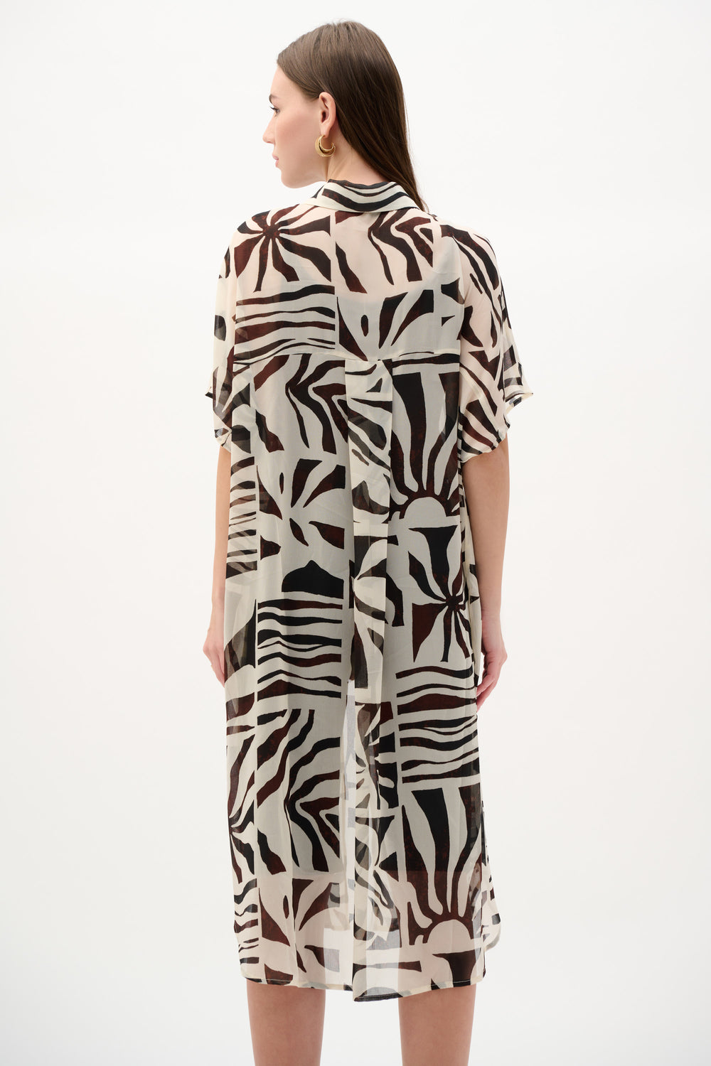 Woman wearing a patterned dress on a white background