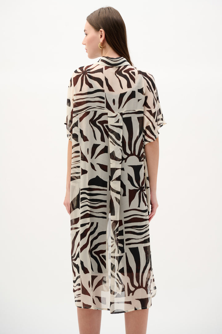 Woman wearing a patterned dress on a white background