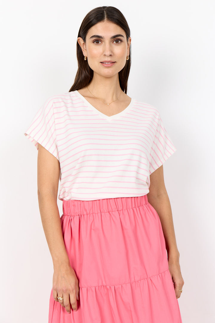 Woman wearing a white striped top and pink skirt on a white background