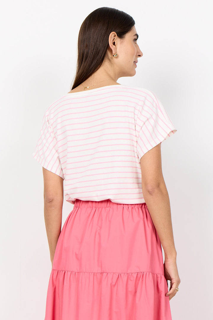 Woman wearing a white and pink striped top with a pink skirt on a white background