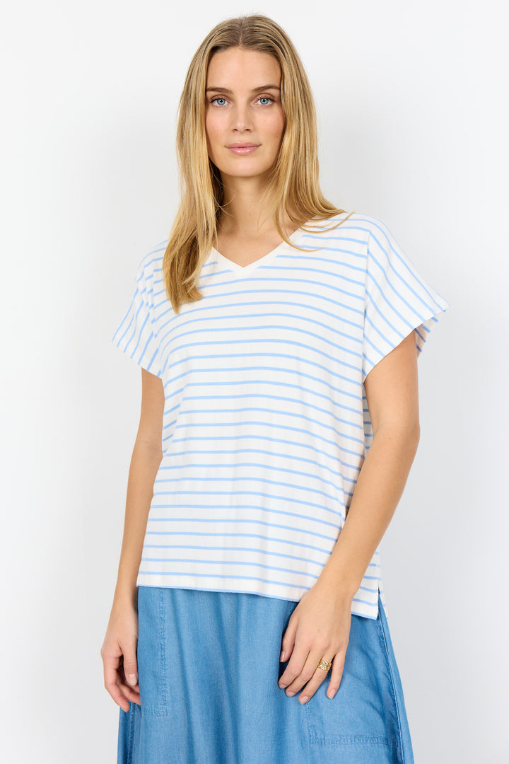 Woman wearing a blue and white striped t-shirt with a plain background