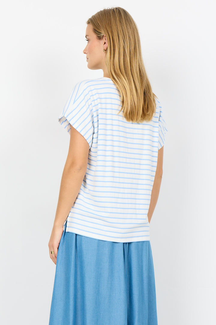 Woman wearing a striped shirt and blue pants on a white background
