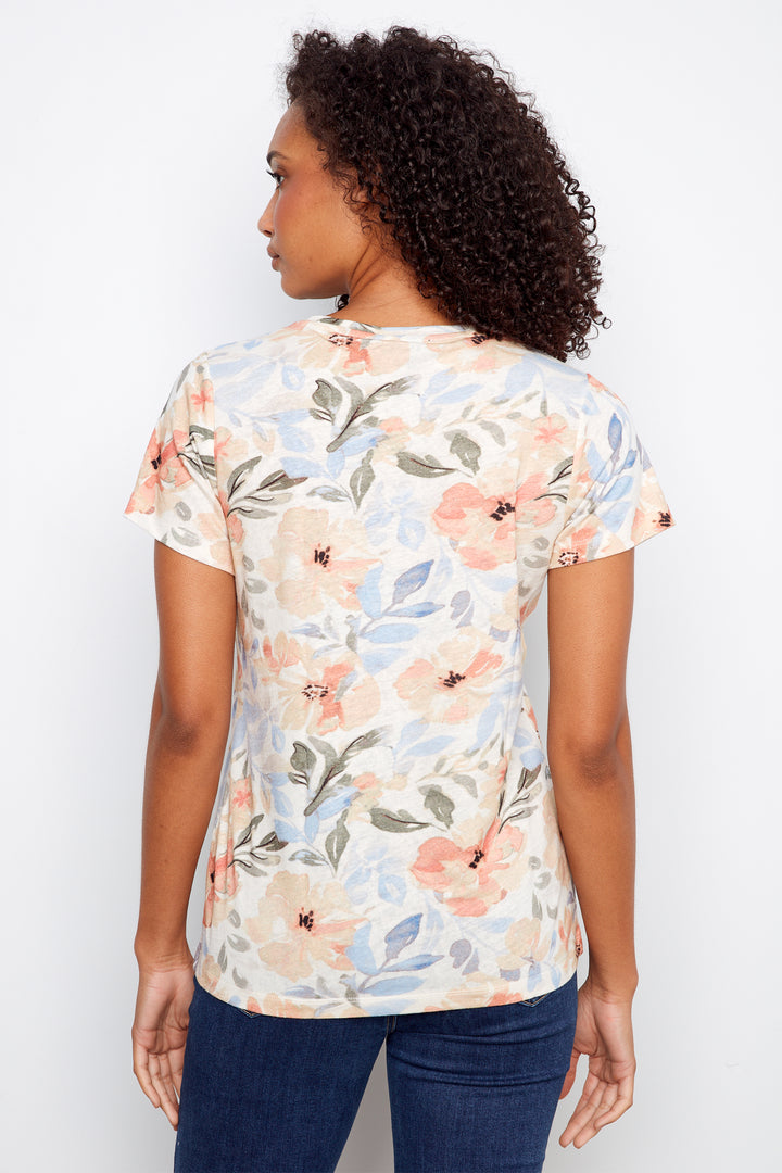 Woman wearing a floral print shirt against a white background