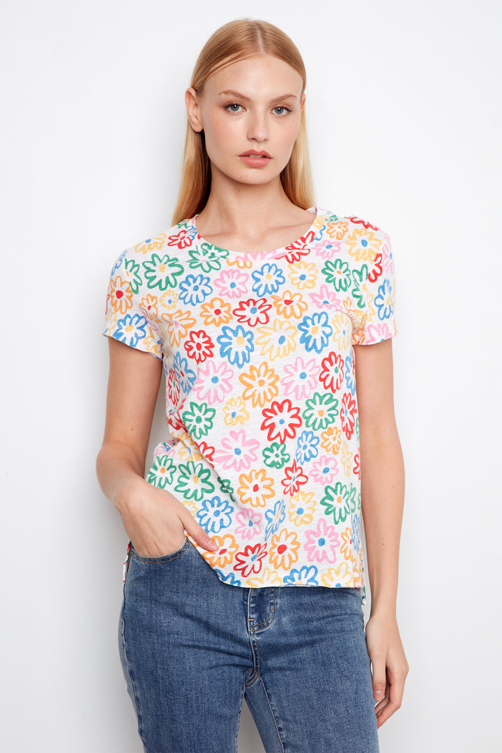 Woman wearing a colorful floral t-shirt against a white background