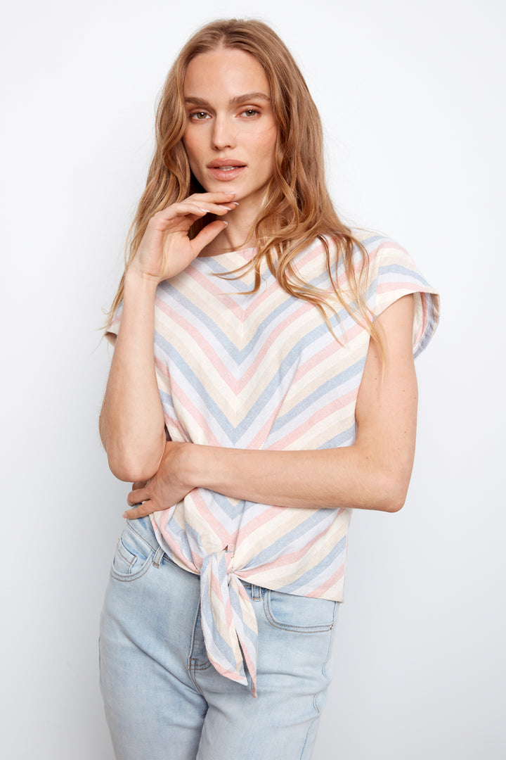 Woman wearing a striped shirt and jeans against a white background