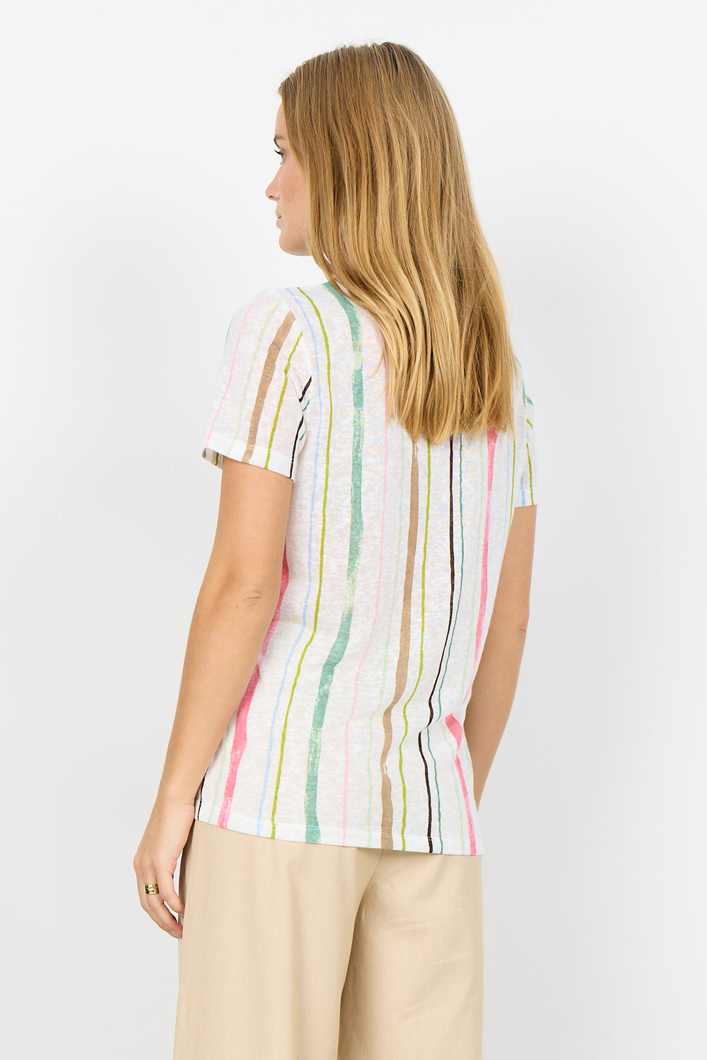 Woman wearing a colorful striped shirt on a white background