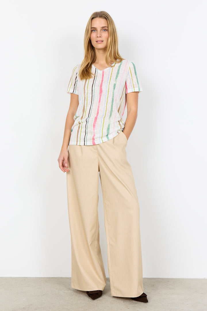 Woman wearing a striped shirt and beige pants on a white background