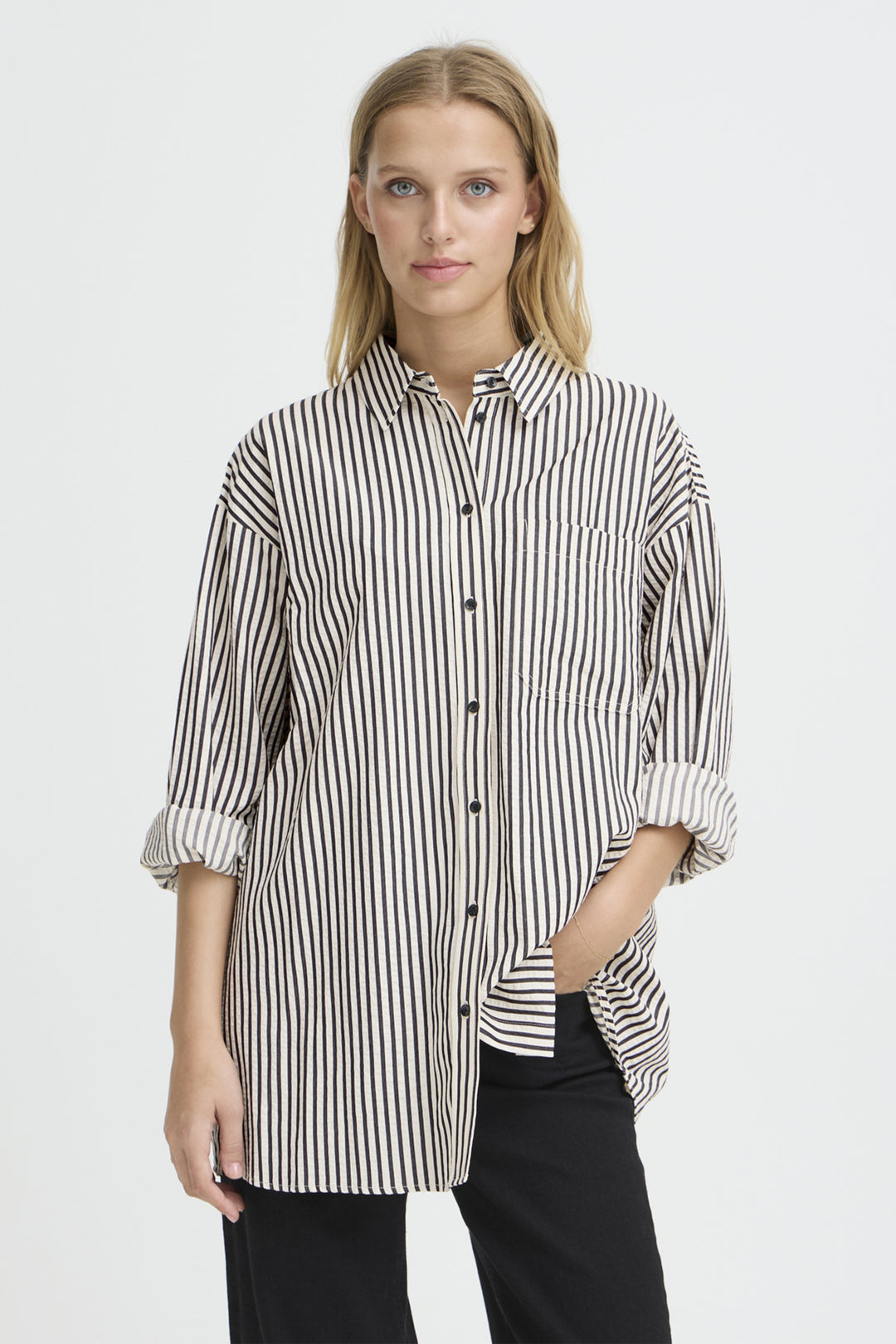 Woman wearing a black and white striped shirt on a white background
