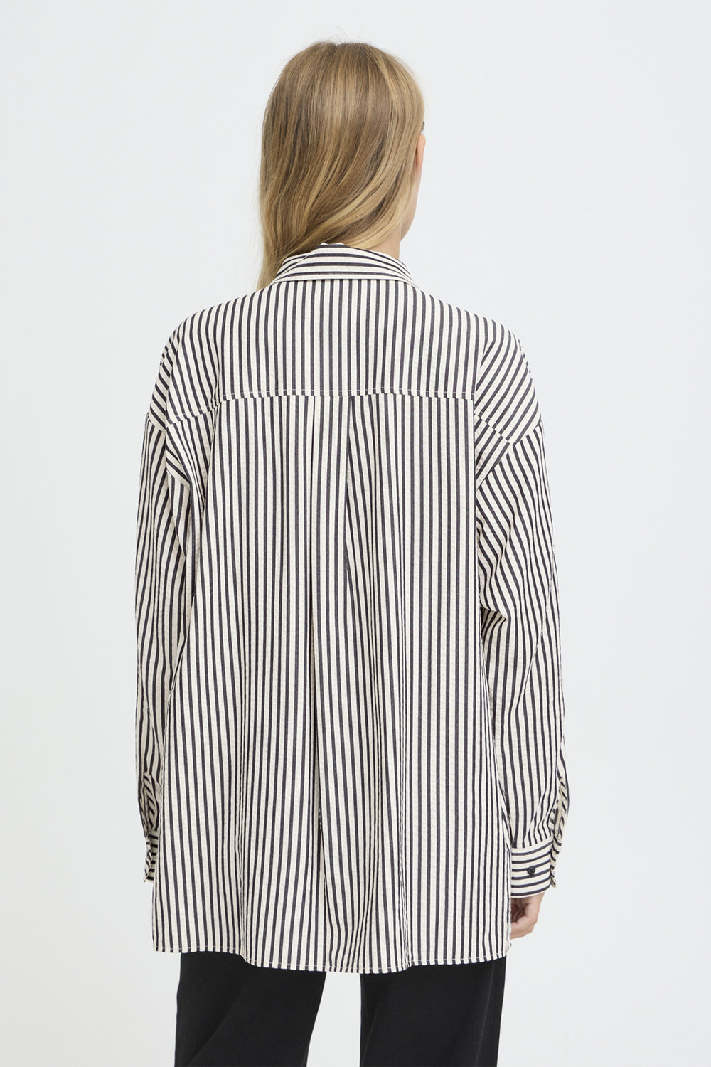 Person wearing a black and white striped shirt on a white background