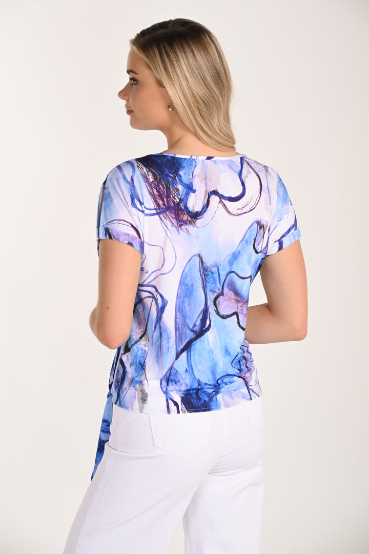 Woman wearing a blue abstract patterned top on a white background