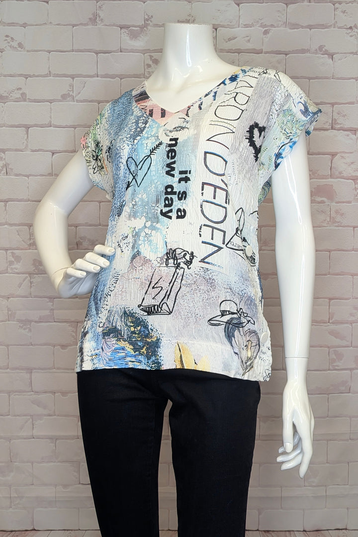 Mannequin wearing a graphic t-shirt with text and designs against a brick wall background