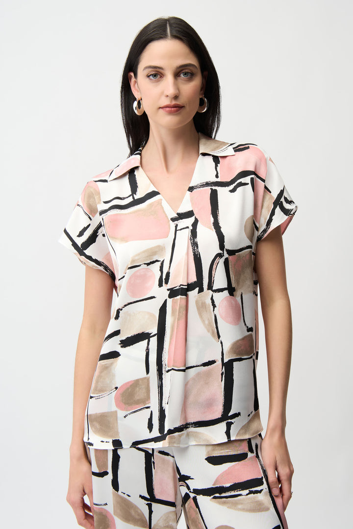 Woman wearing a short-sleeve blouse with abstract pattern on a white background