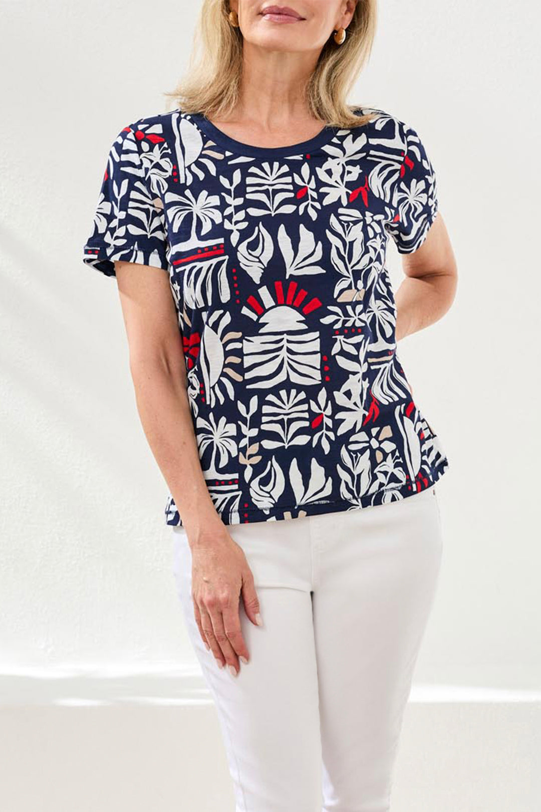 Woman wearing a patterned top with a white background
