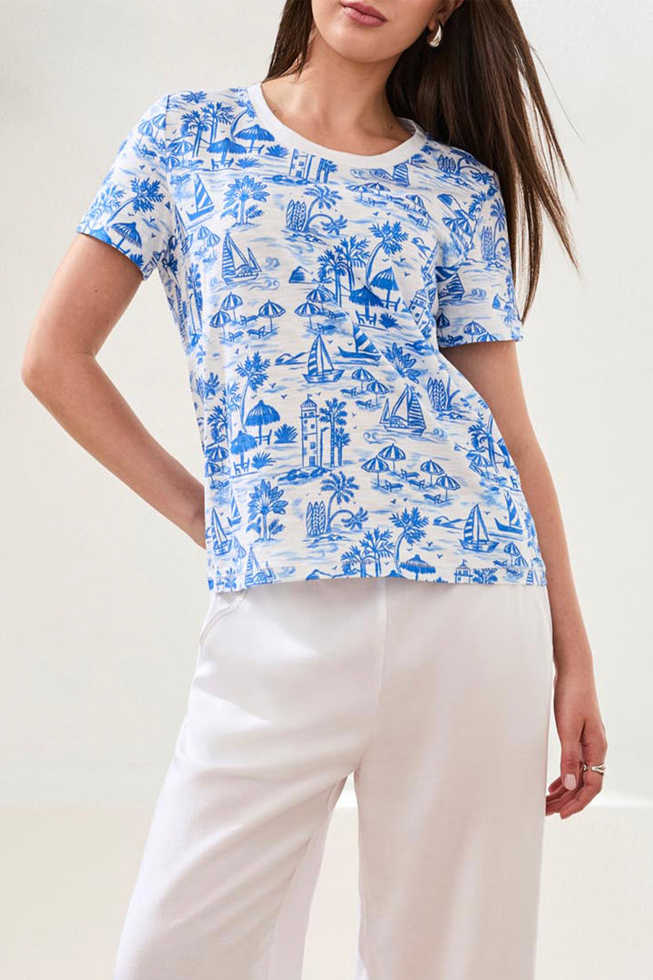 Woman wearing a blue and white patterned shirt with a plain background