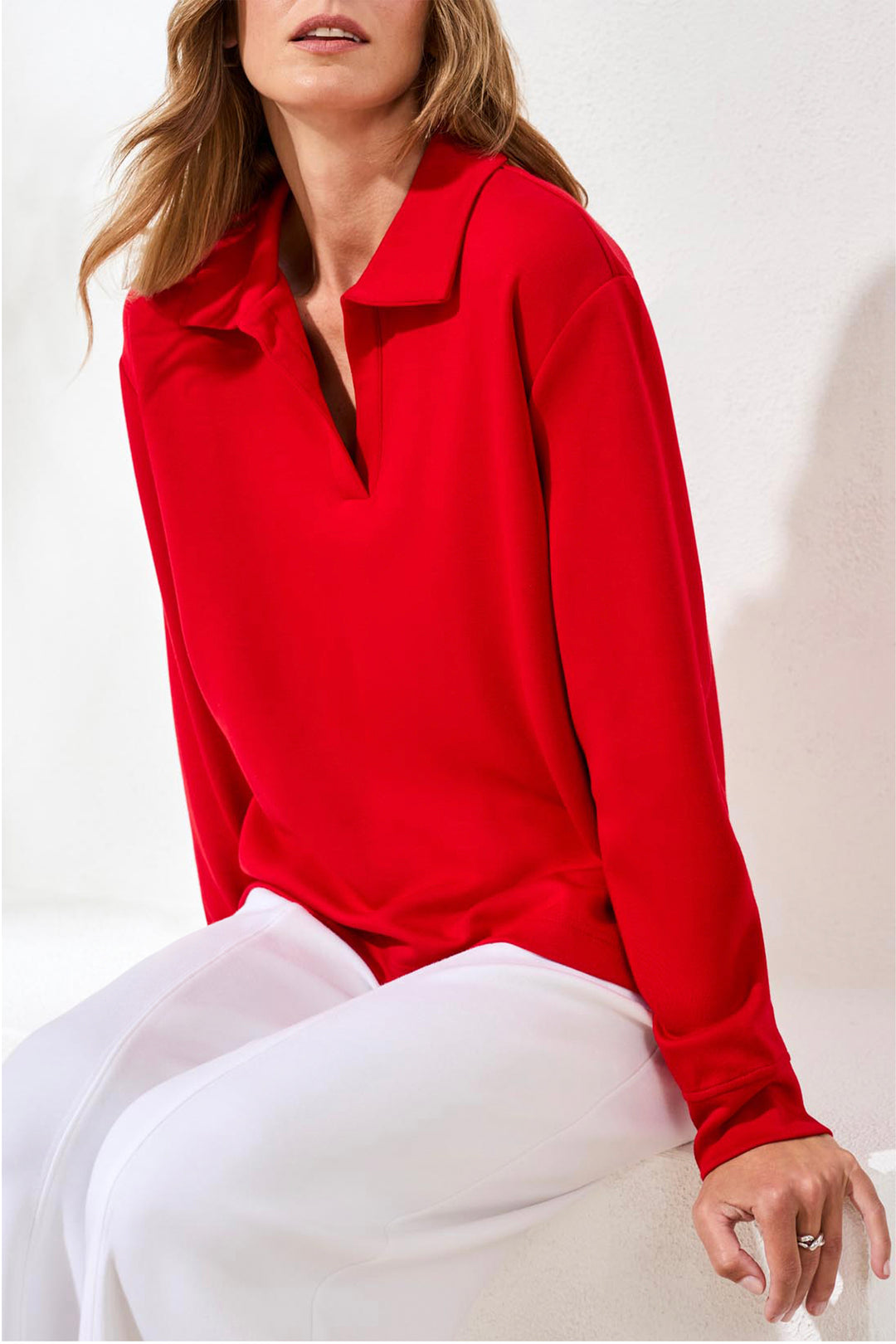 Woman wearing a red blouse with a white background