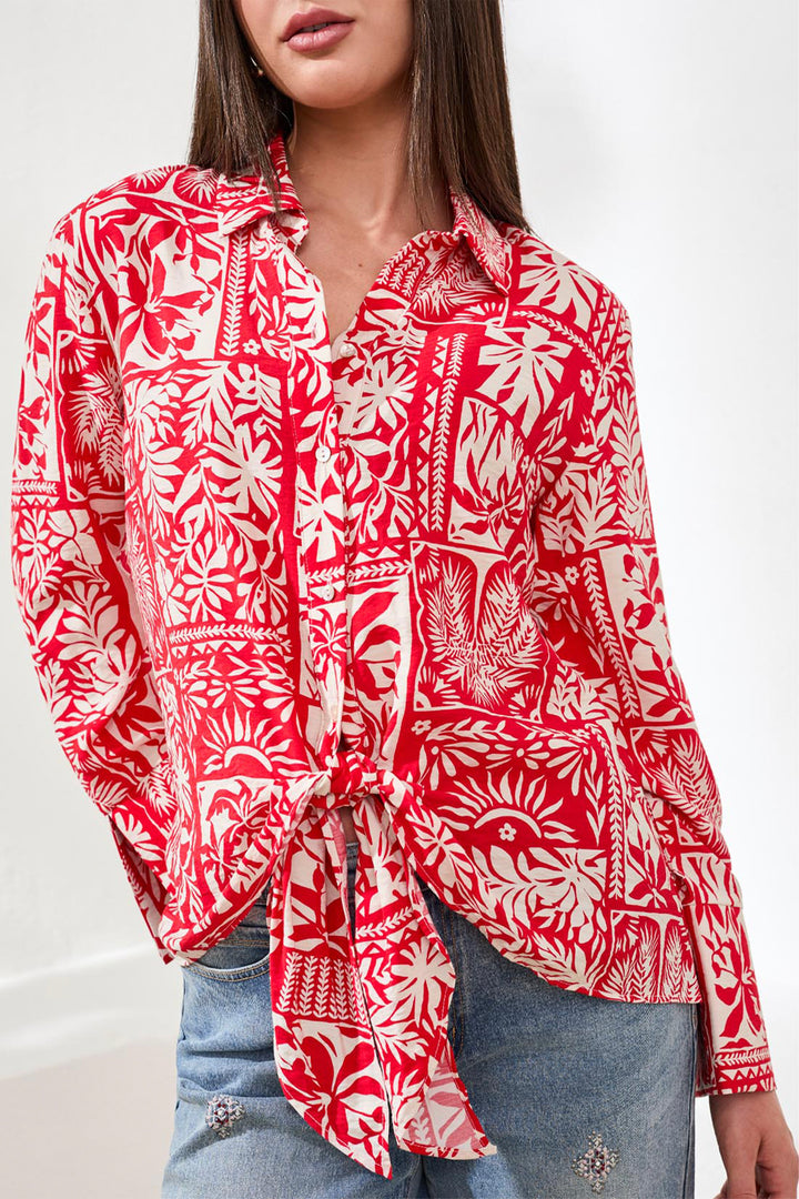 Red and white patterned patch print shirt worn by a person on a white background