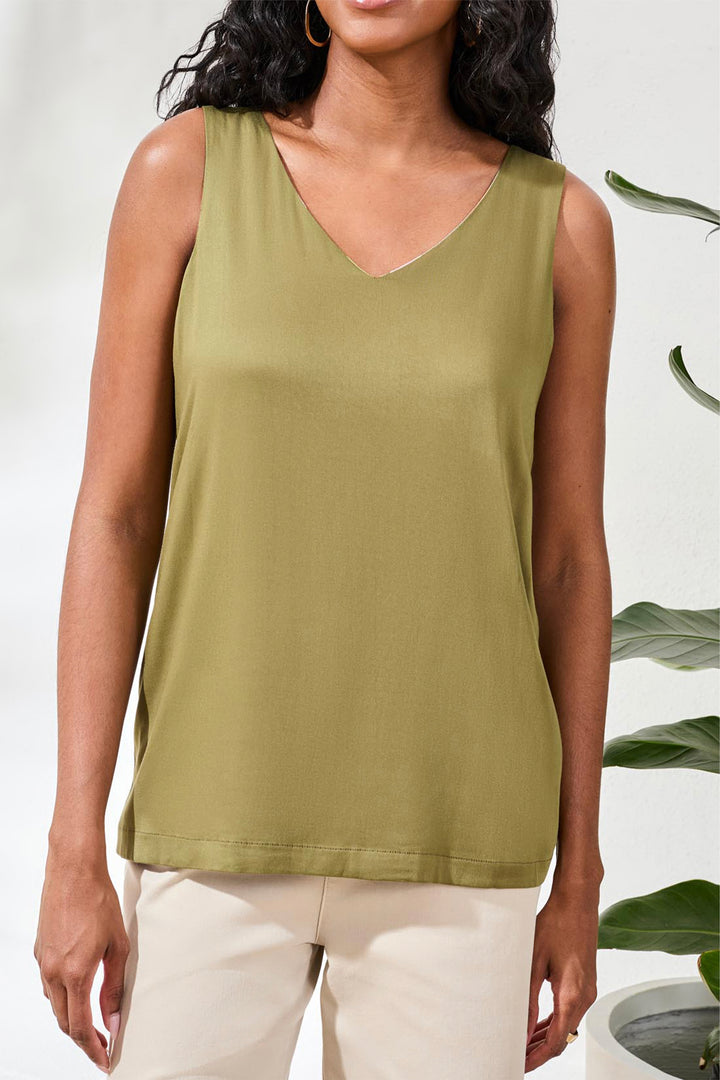 Woman wearing a green tank top against a white background