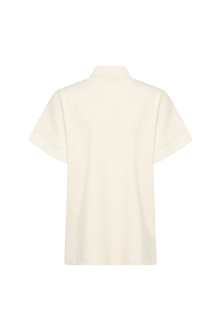 Cream short sleeve half zip top on a white background. 