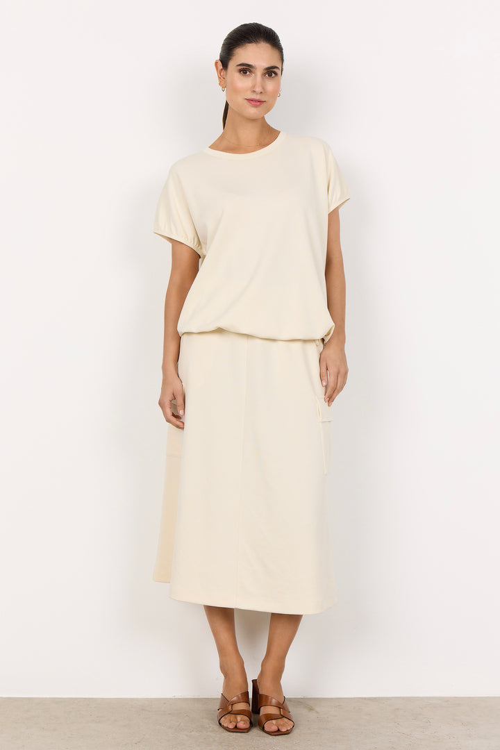 woman wearing a cream coloured t-shirt on white background