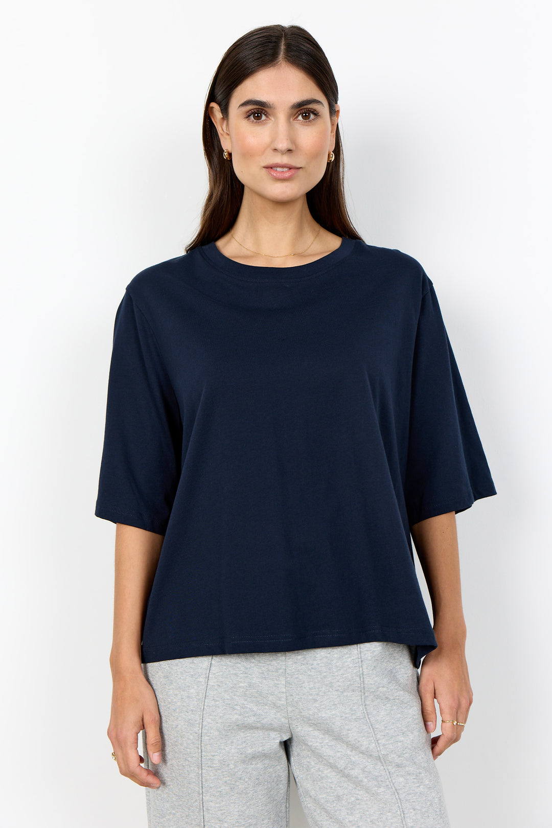 woman wearing half sleeve t-shirt on a white background. 