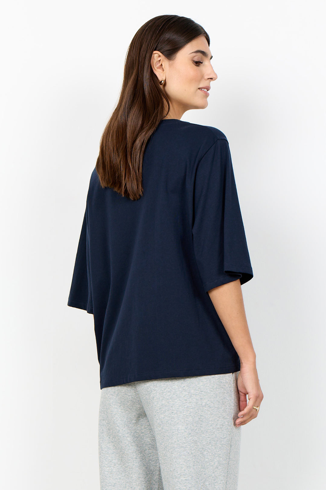 woman wearing half sleeve t-shirt on a white background. 