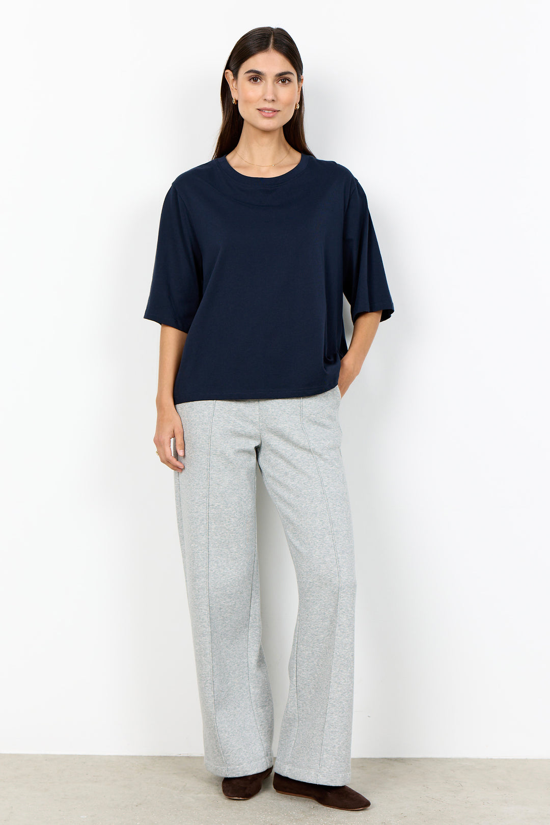 woman wearing half sleeve t-shirt on a white background. 