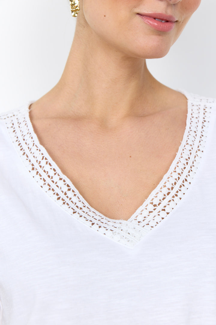 casual t-shirt with lace detail along neckline on a white background. 