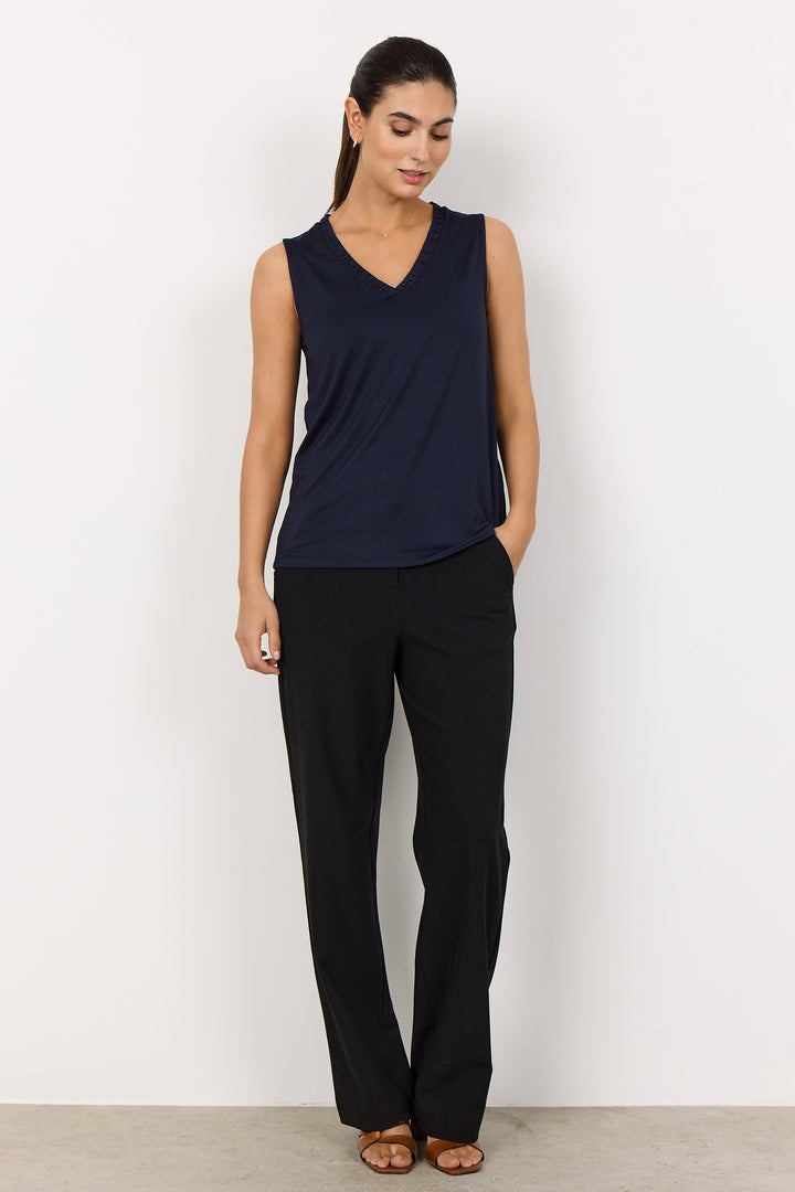 woman wearing a casual wide strap navy tank top on a  white background.