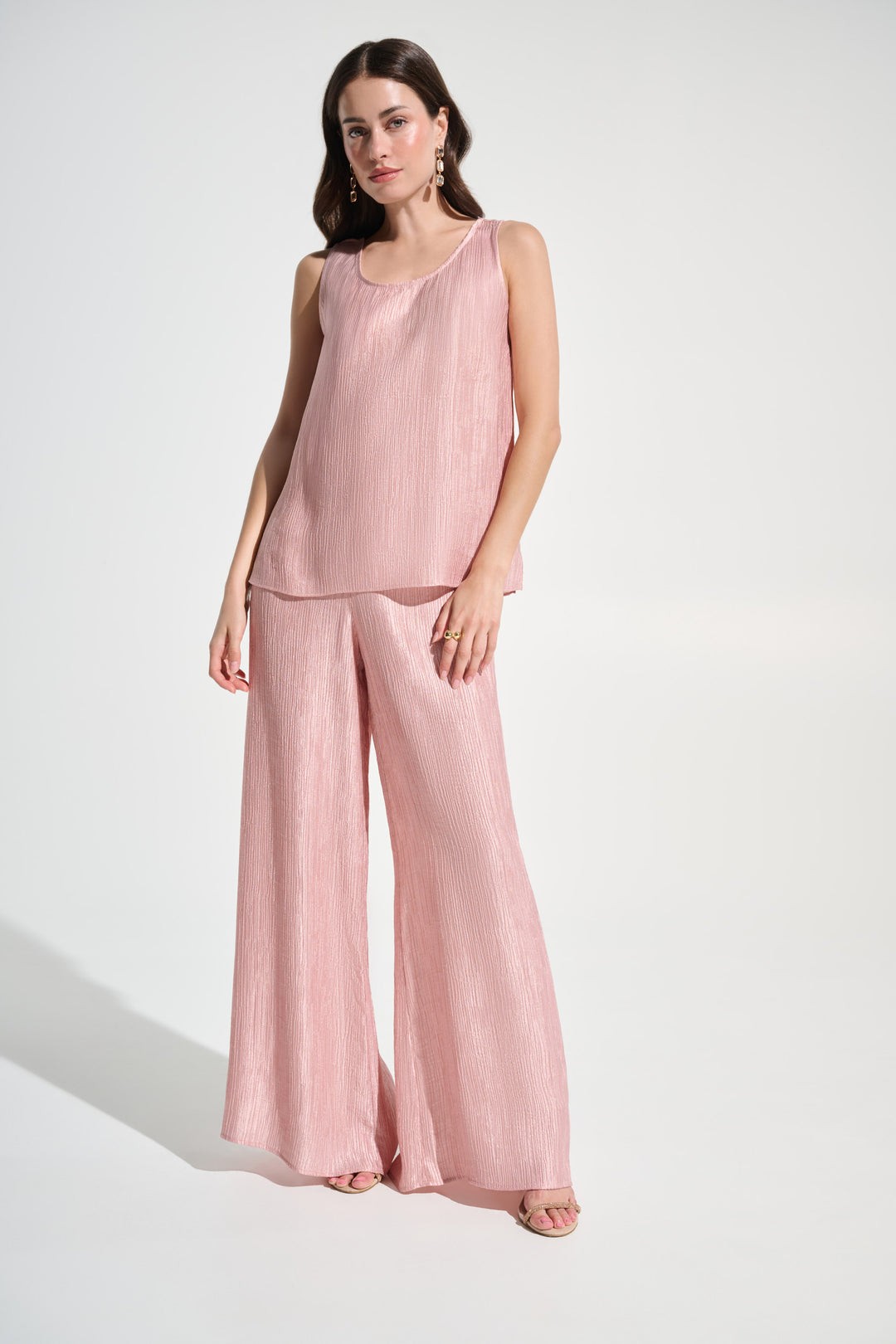 Woman wearing a pink matching set on a white background