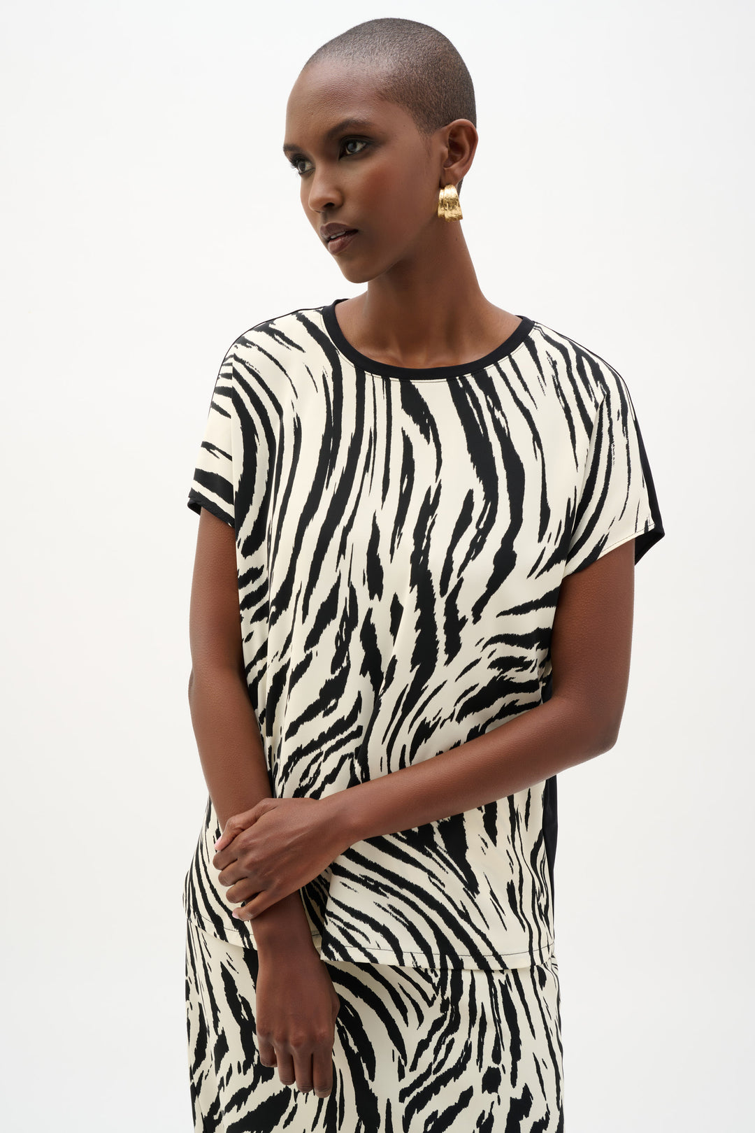Woman wearing a zebra print dress on a white background