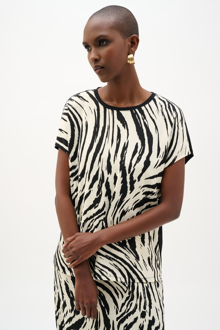 Woman wearing a zebra print dress on a white background