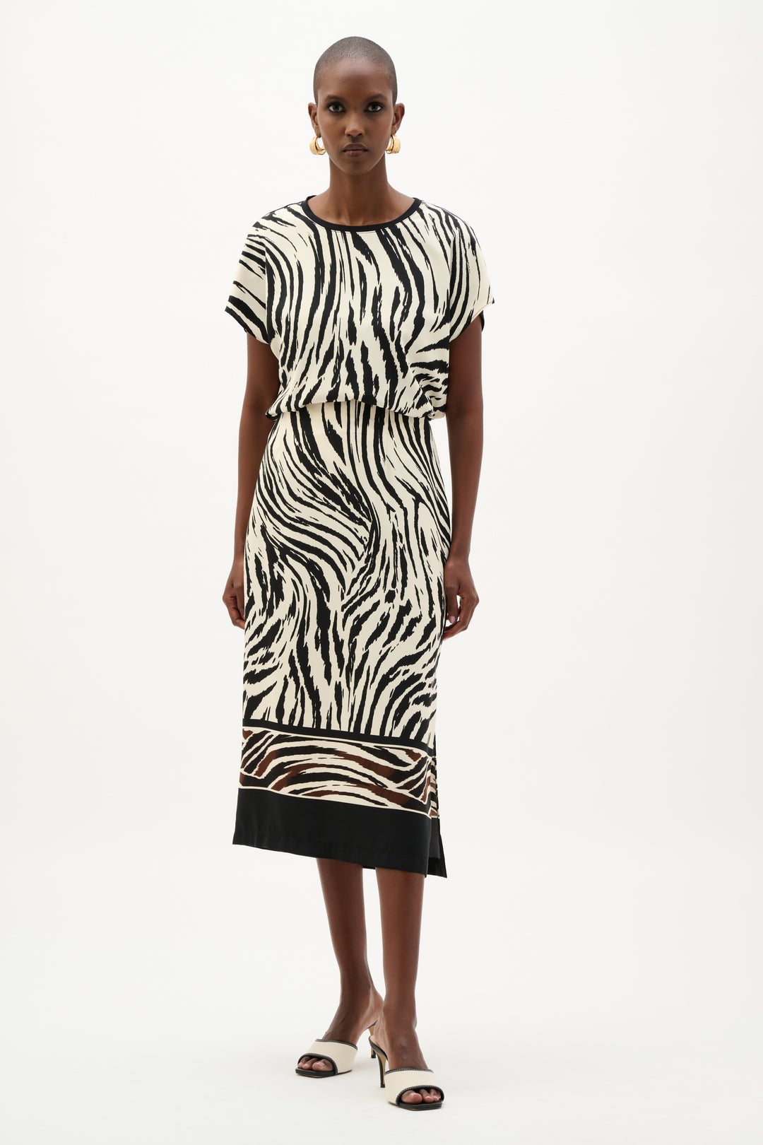 Woman wearing a zebra print dress on a white background