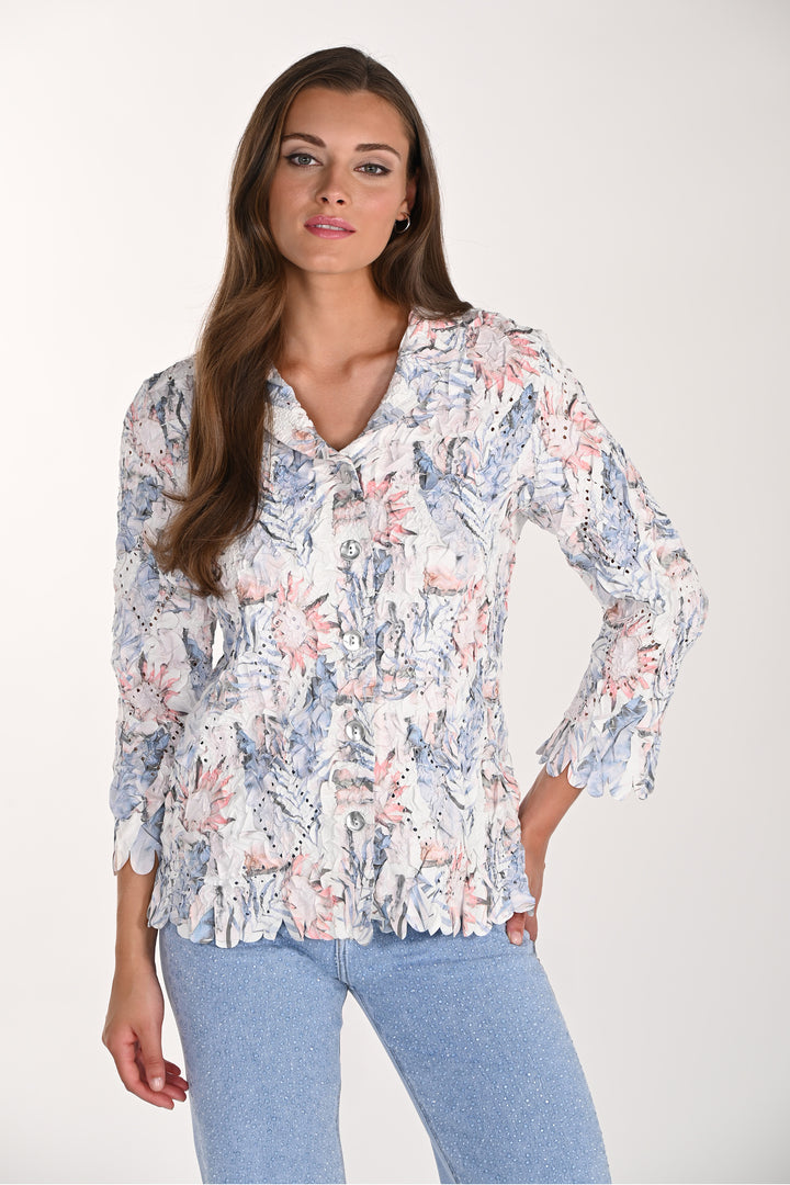 Woman wearing a floral blouse with long sleeves on a white background