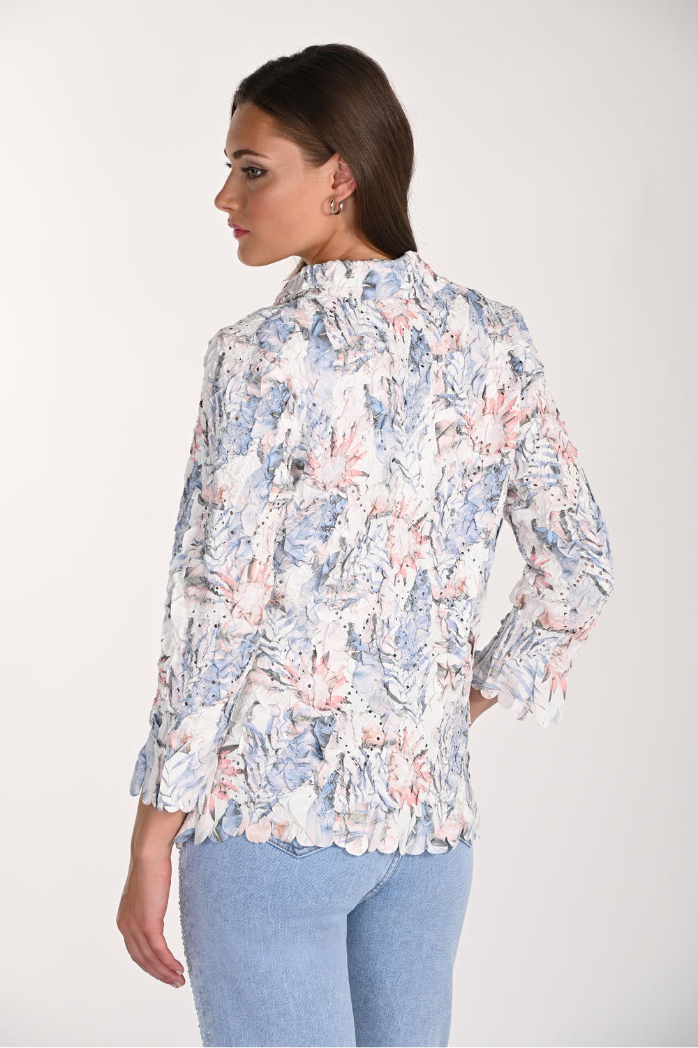 Woman wearing a floral blouse with a white background