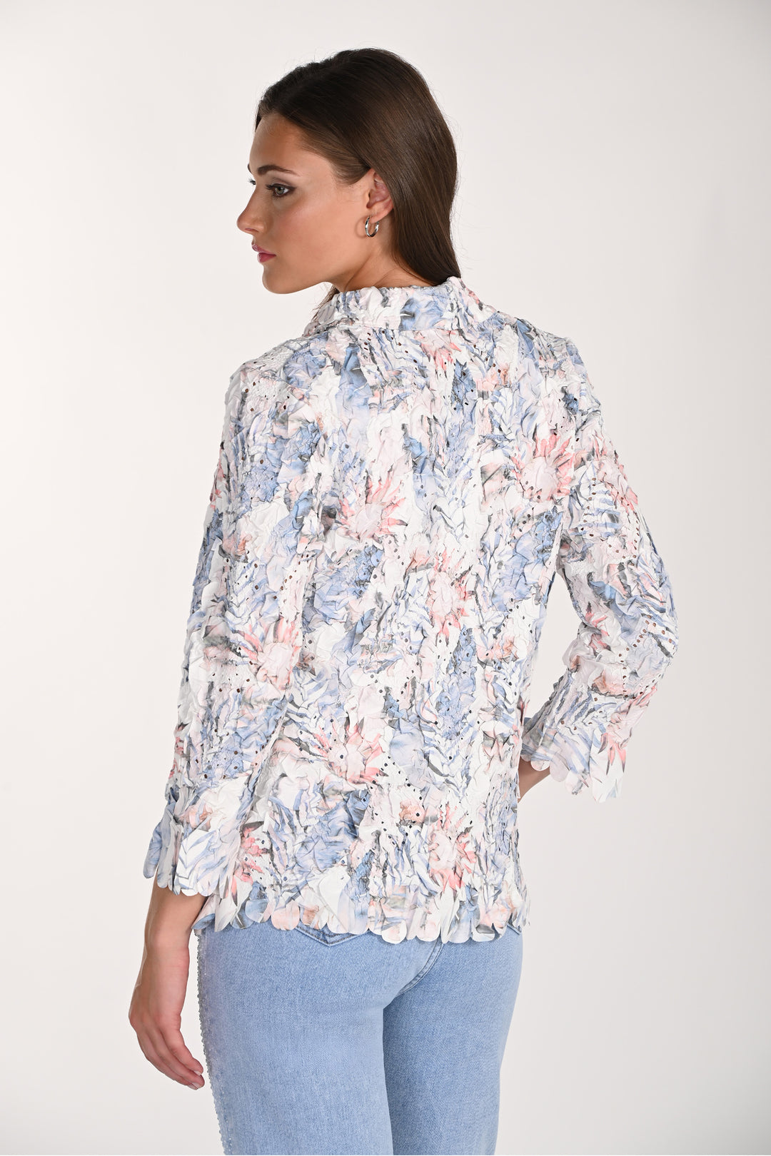 Woman wearing a floral blouse with a white background