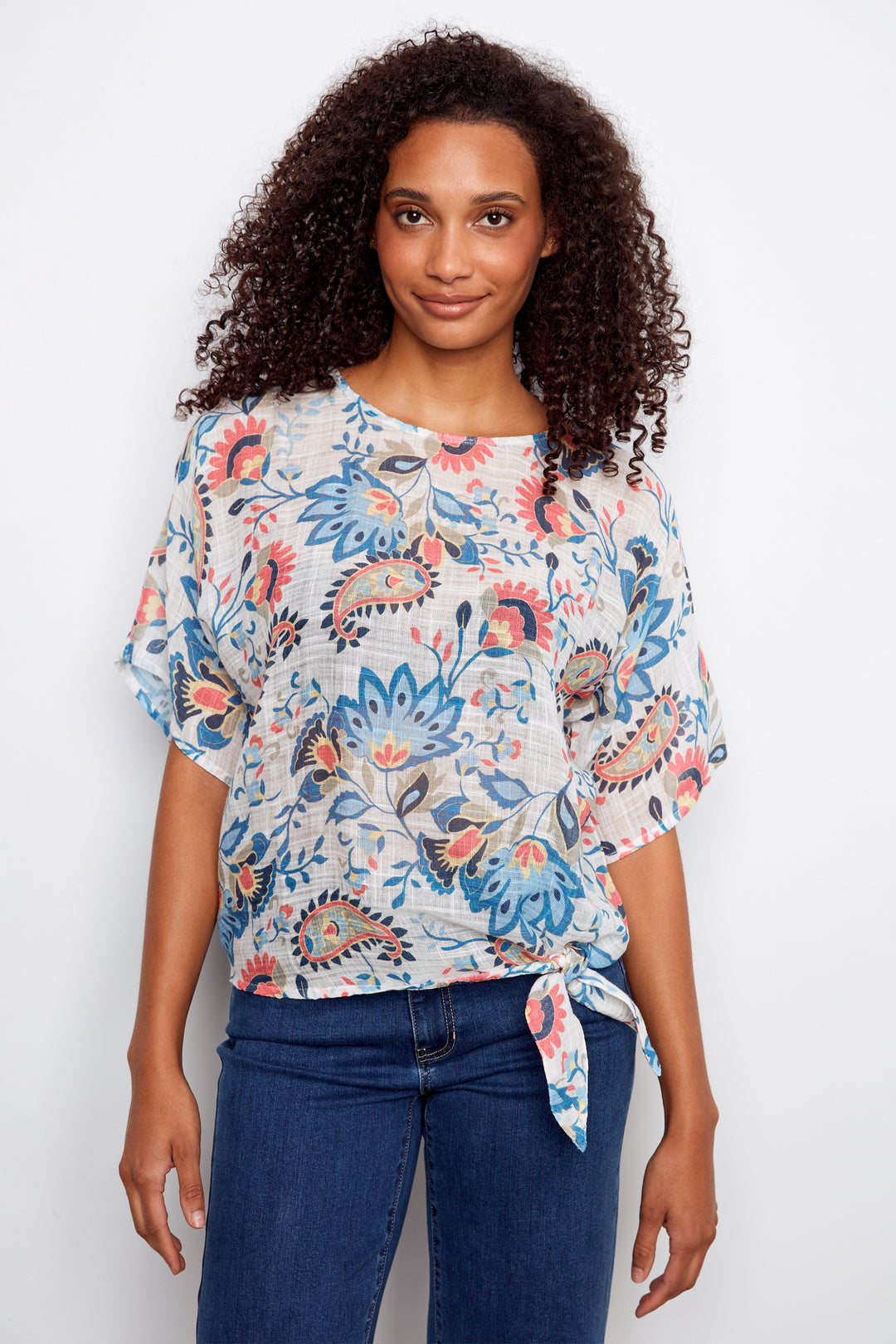 Woman wearing a floral blouse with a white background