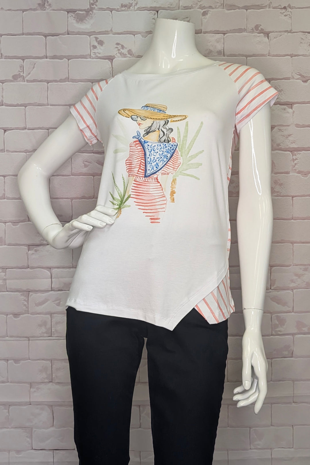 Mannequin wearing a white t-shirt with colorful graphic design against a brick wall background