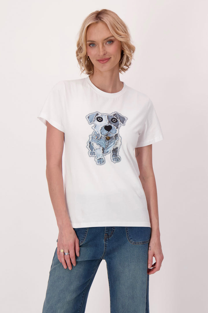 Woman wearing a white t-shirt with a dog graphic on a plain background