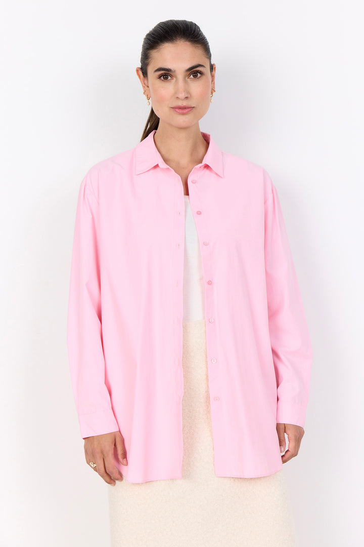 Woman wearing a light pink shirt against a white background