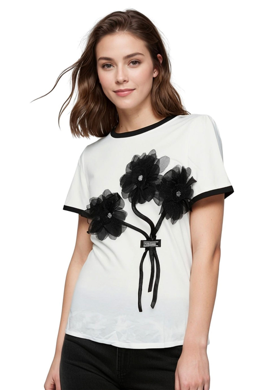 Woman wearing a white t-shirt with black floral designs on a white background