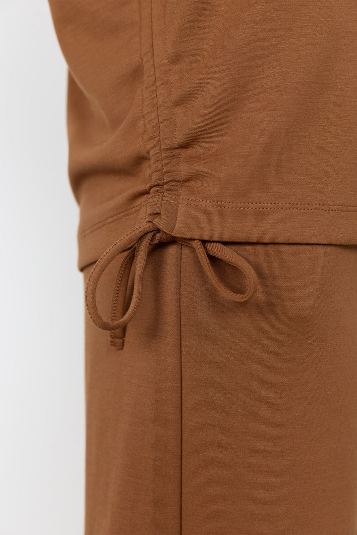 Toffee-colored top and matching shorts against a white background.