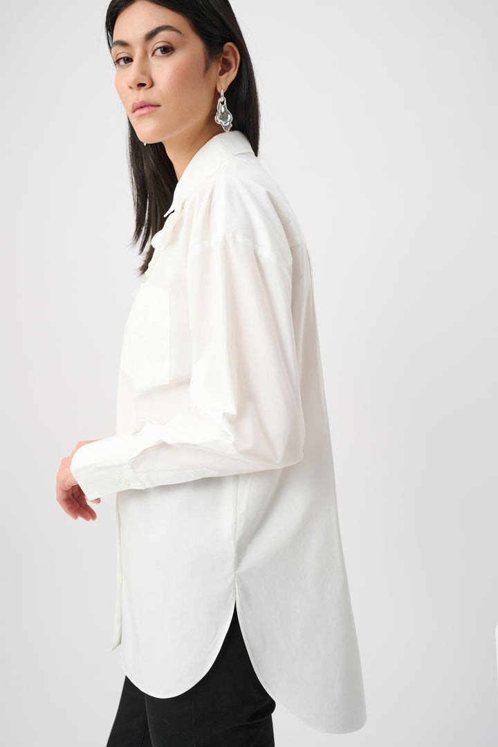Woman wearing a white blouse with a plain background
