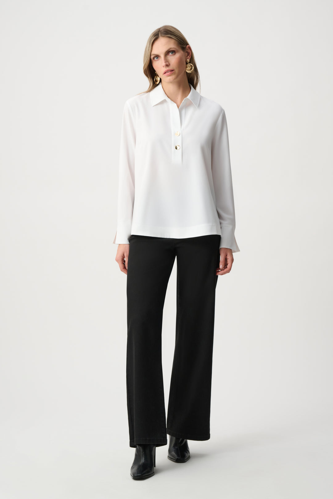 Woman wearing a white blouse and black pants on a white background