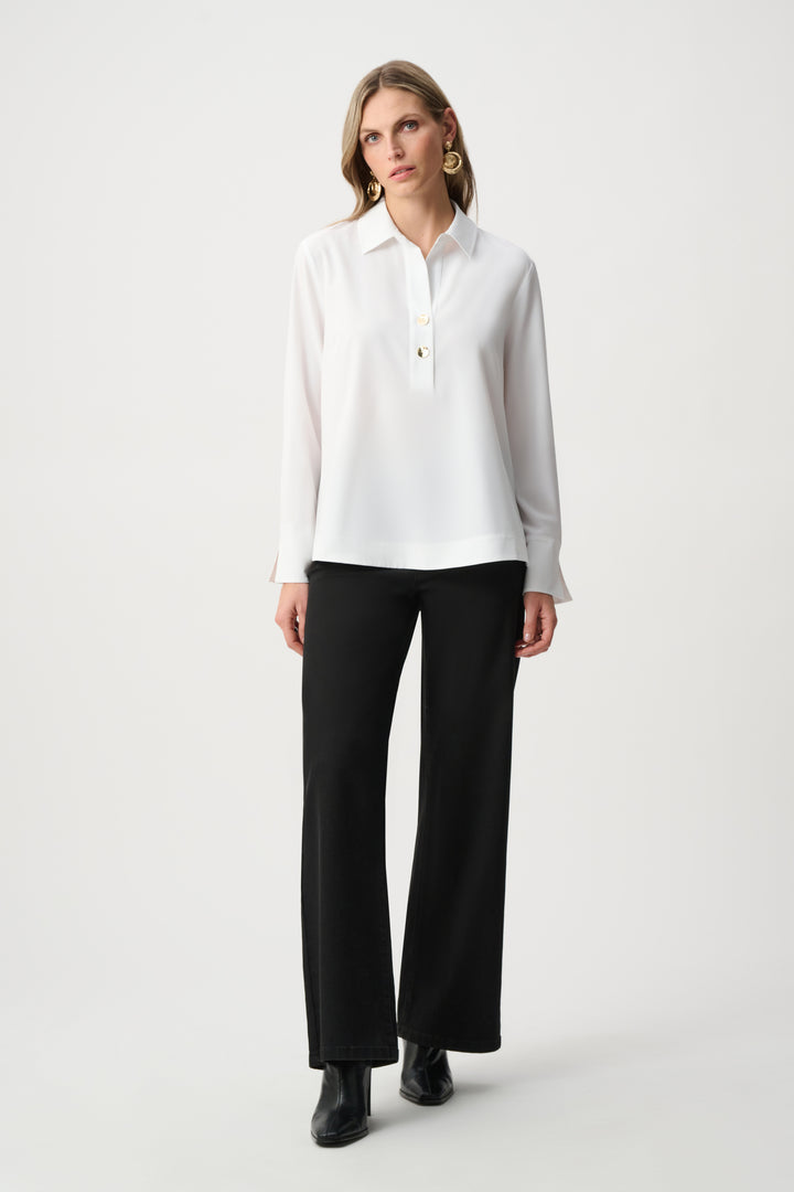 Woman wearing a white blouse and black pants on a white background