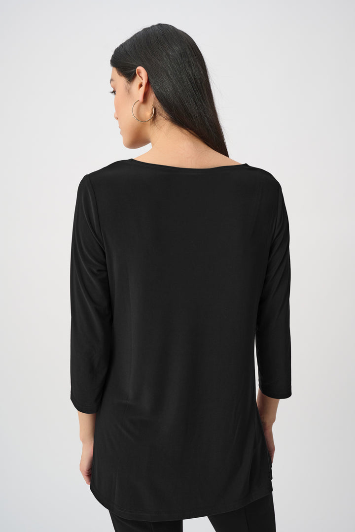 Woman wearing a black long-sleeve top on a white background