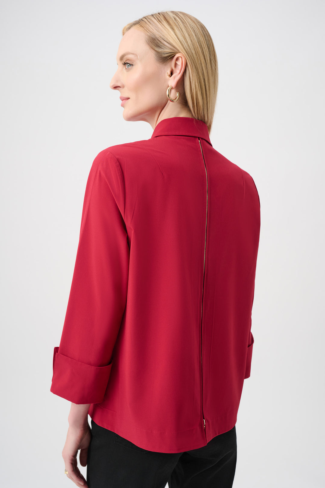 Woman wearing a red blouse against a white background